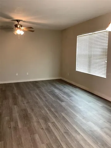 wooden floor in an empty room with a window