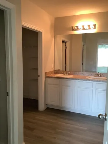 a view of a bathroom with a sink and mirror