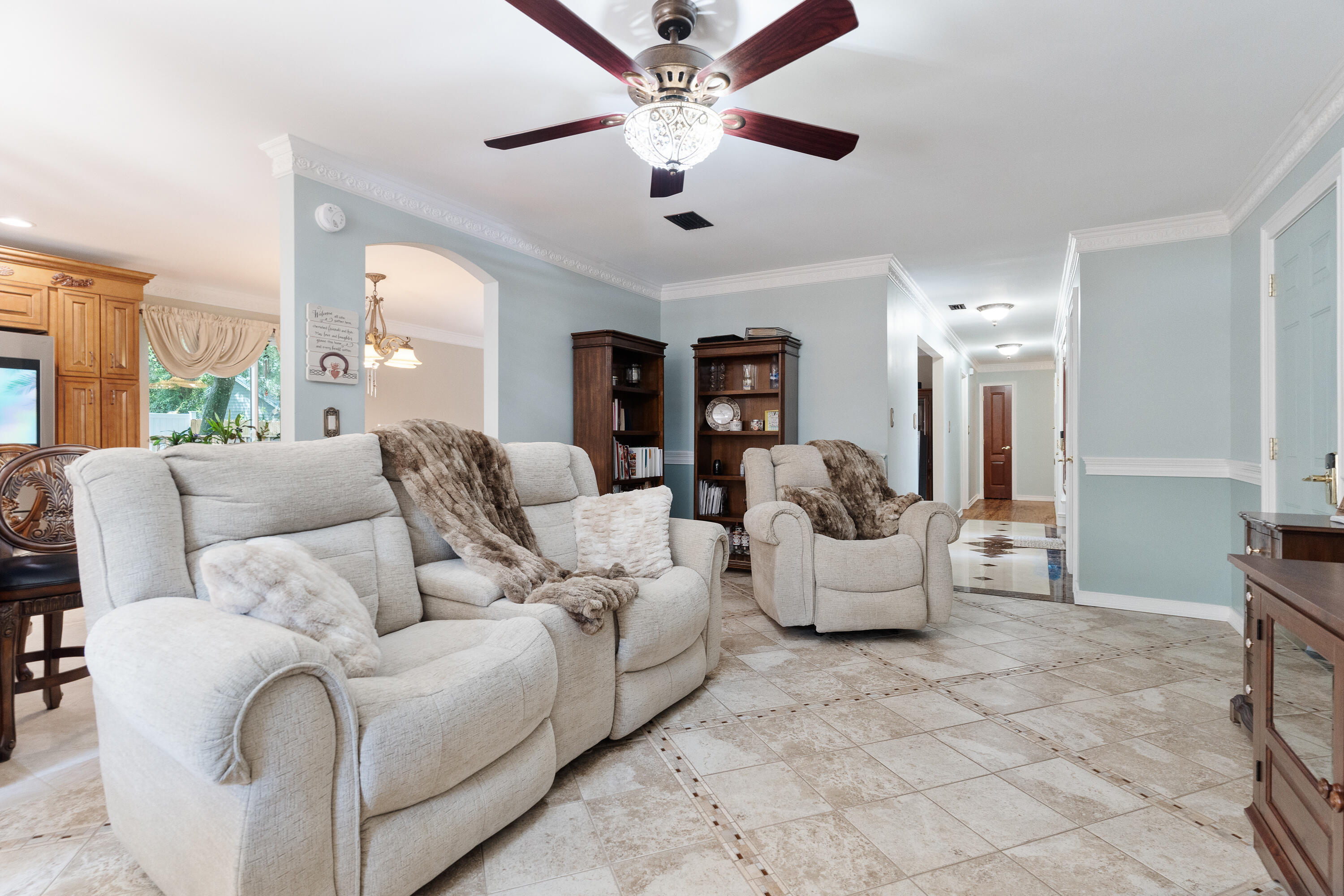 149 Raintree Boulevard Niceville, FL 32578 - Photo 11 of 72 a living room with furniture and a chandelier