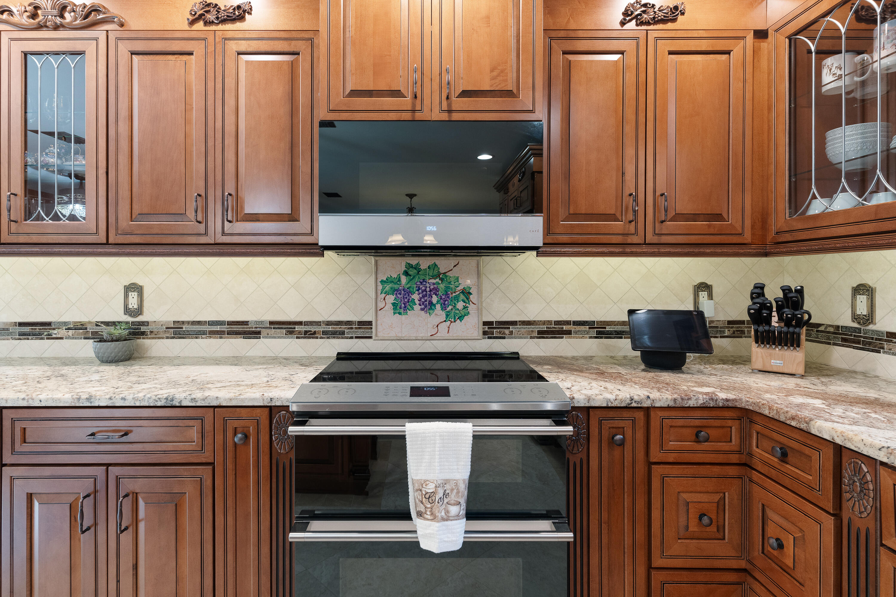 149 Raintree Boulevard Niceville, FL 32578 - Photo 14 of 72 a kitchen with granite countertop a stove a sink and dishwasher wooden cabinets with granite countertops