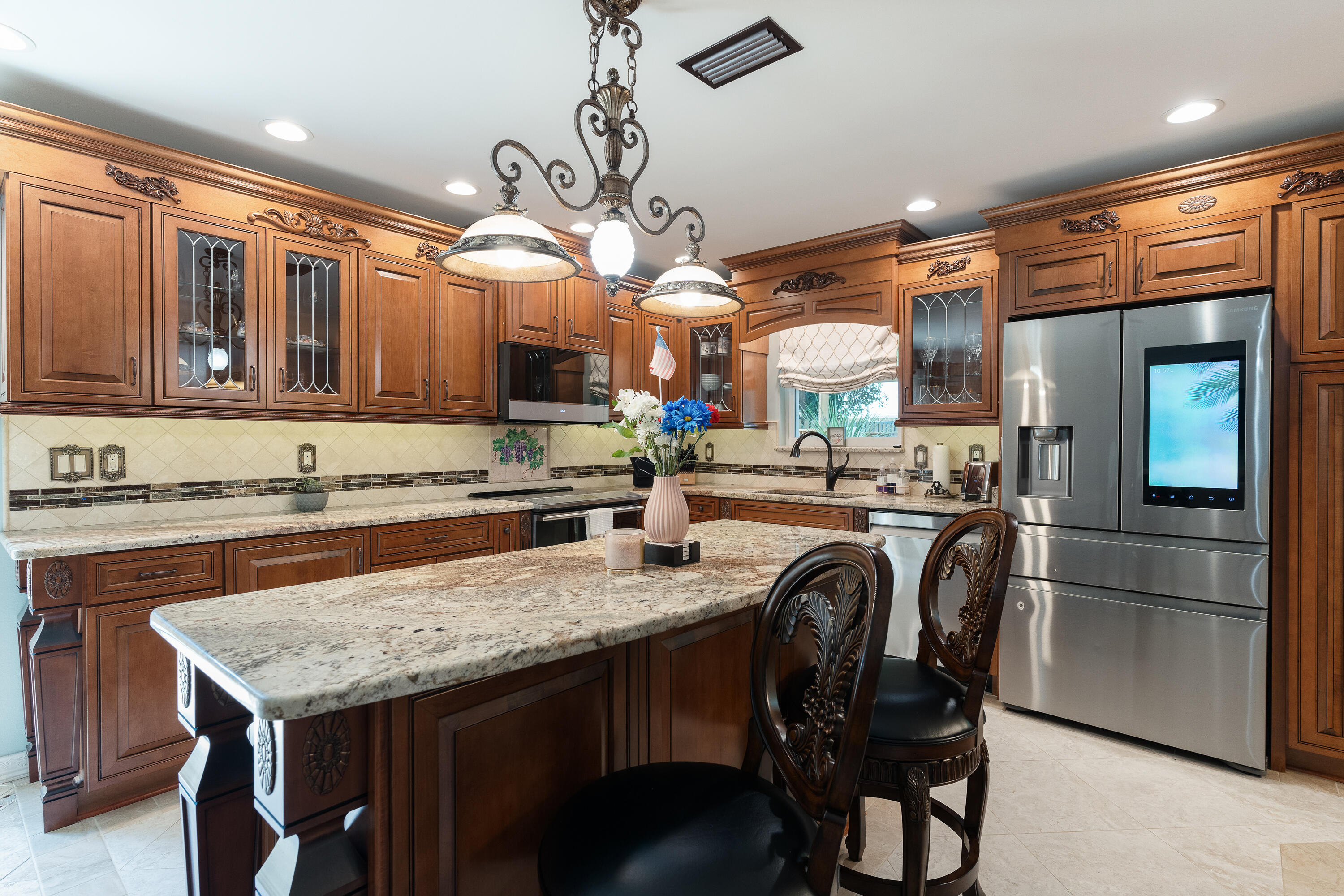 149 Raintree Boulevard Niceville, FL 32578 - Photo 18 of 72 a kitchen with stainless steel appliances granite countertop a table chairs refrigerator and sink