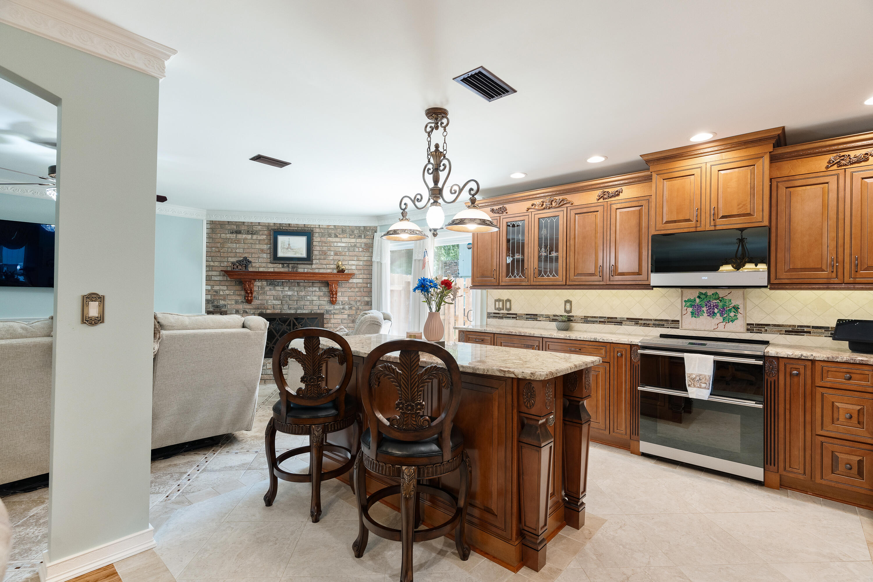 149 Raintree Boulevard Niceville, FL 32578 - Photo 19 of 72 a kitchen with kitchen island granite countertop a sink cabinets and wooden floor