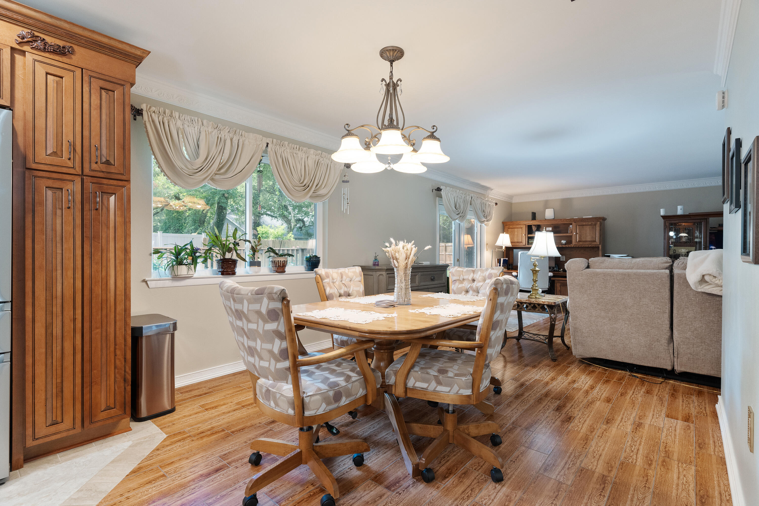 149 Raintree Boulevard Niceville, FL 32578 - Photo 21 of 72 a dining room with furniture a chandelier and wooden floor