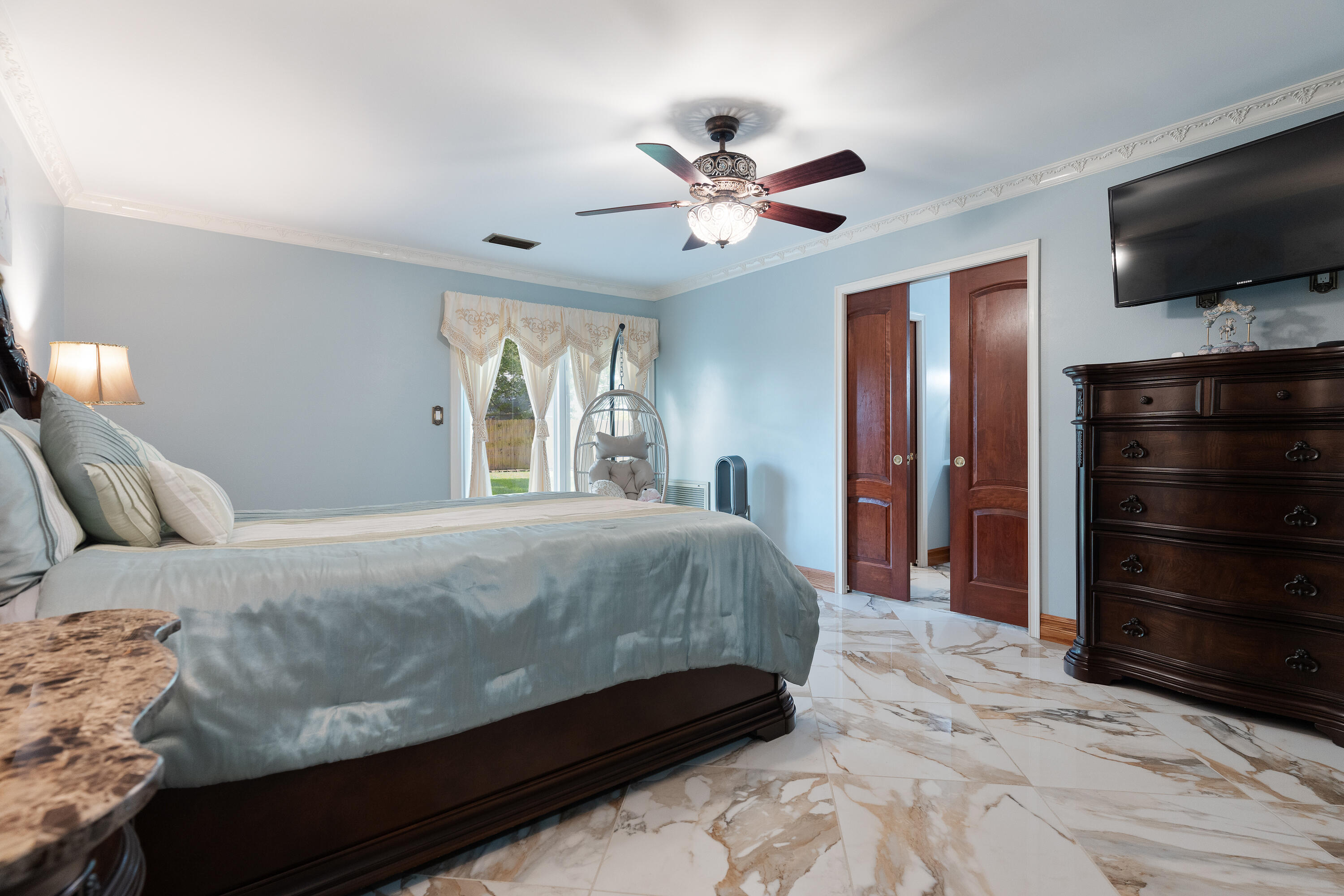 149 Raintree Boulevard Niceville, FL 32578 - Photo 28 of 72 a bedroom with a bed and a flat screen tv