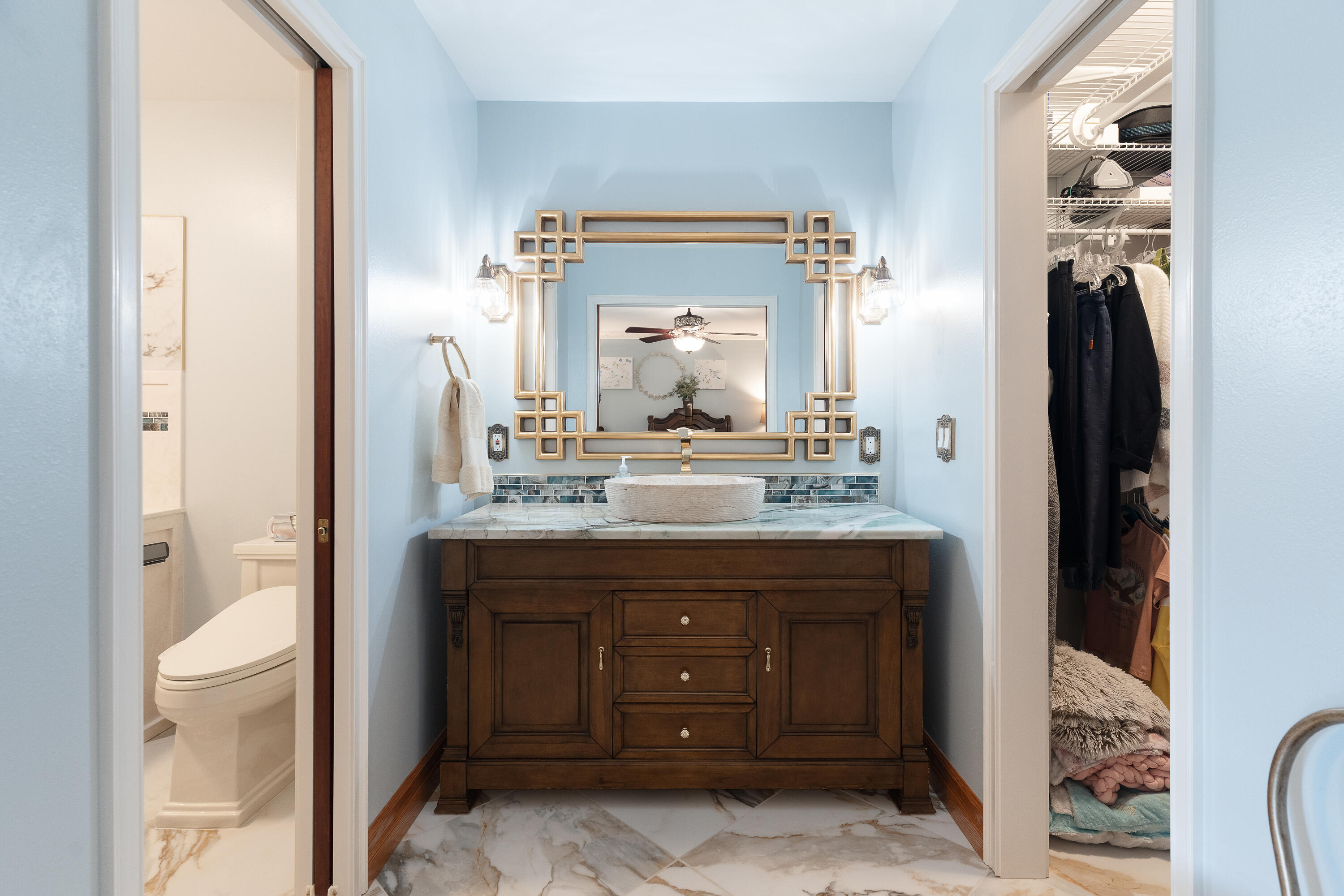 149 Raintree Boulevard Niceville, FL 32578 - Photo 31 of 72 a bathroom with a granite countertop sink a toilet and a mirror