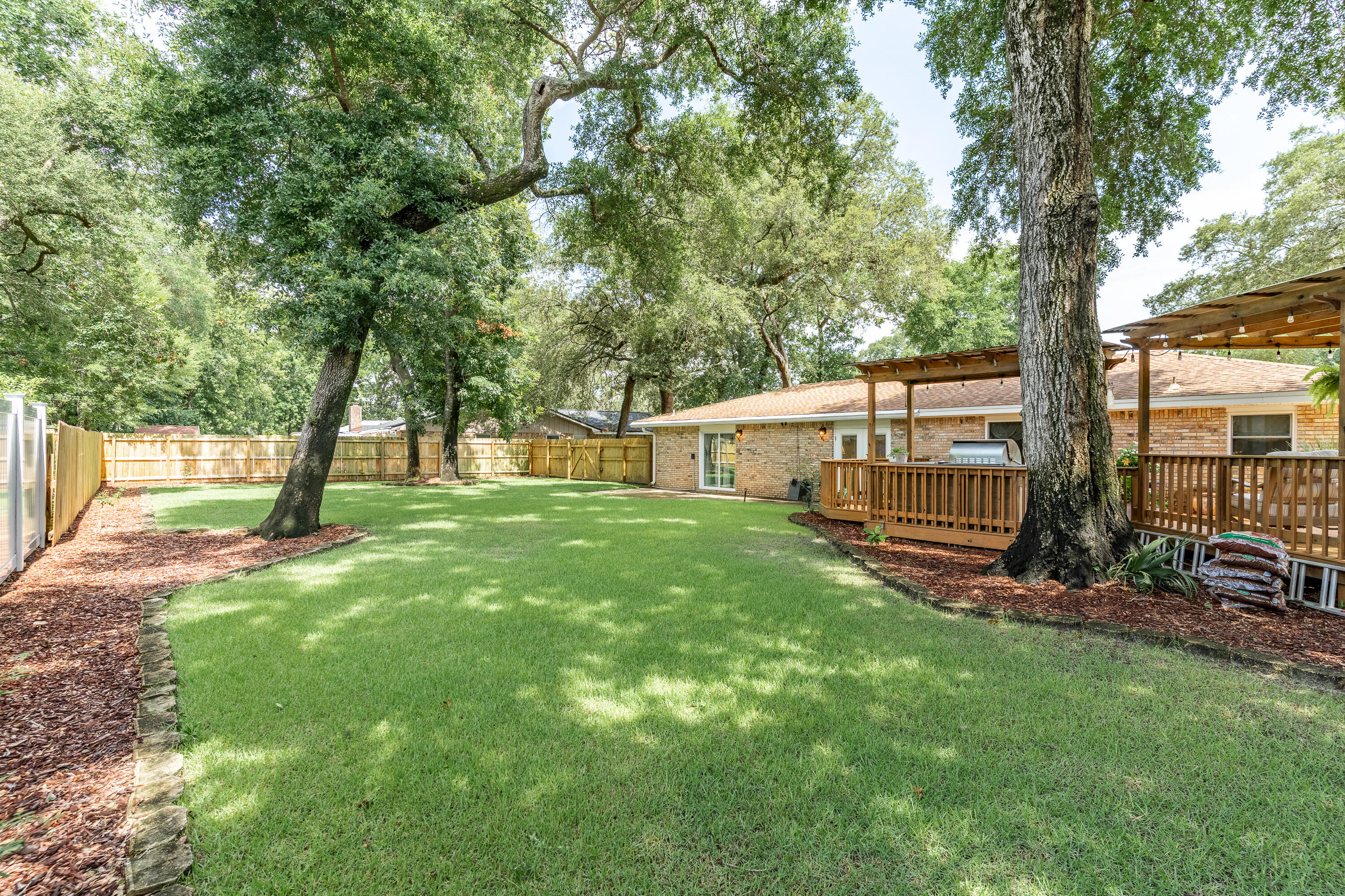 149 Raintree Boulevard Niceville, FL 32578 - Photo 48 of 72 a view of a house with backyard and a tree