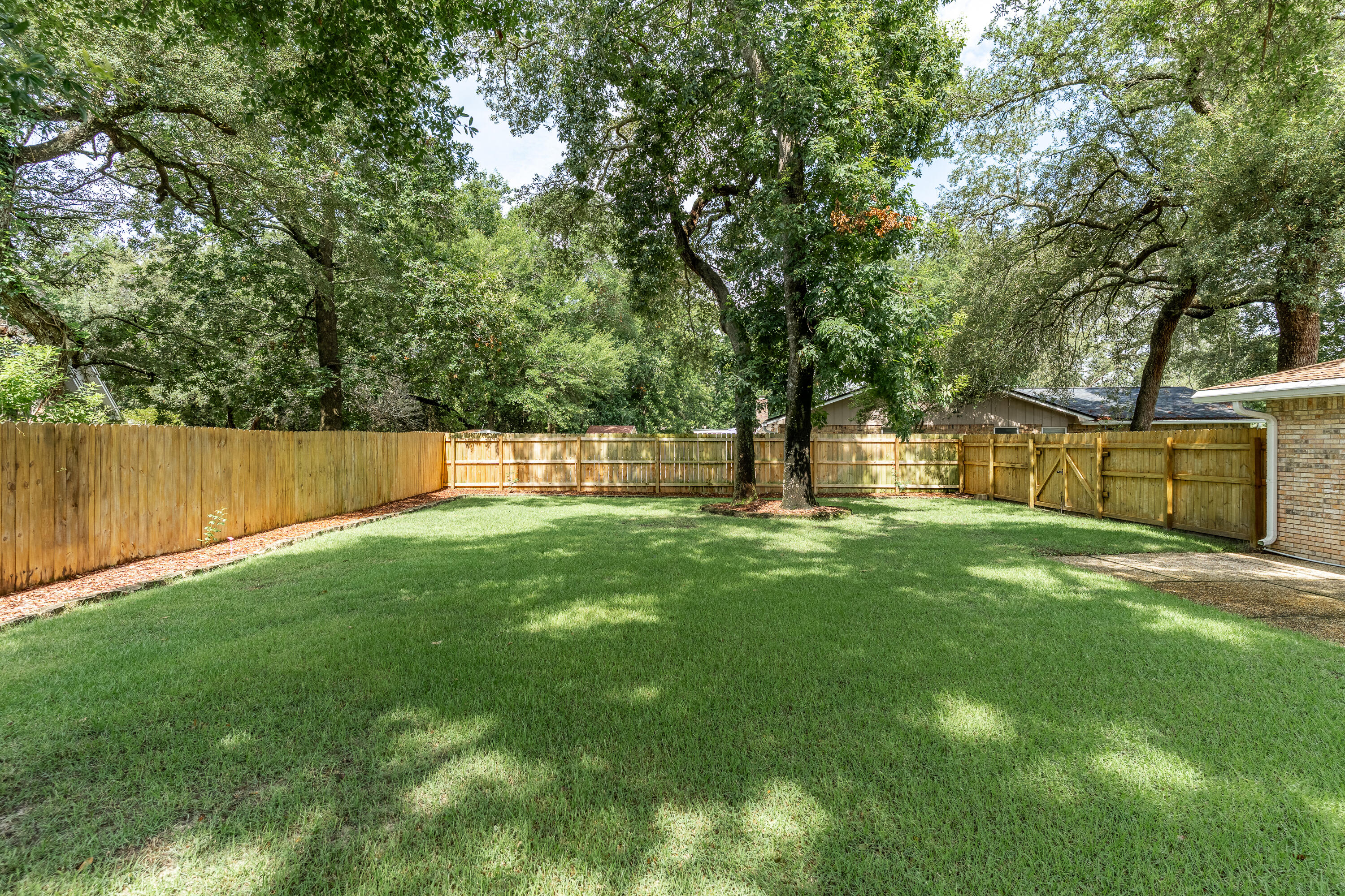 149 Raintree Boulevard Niceville, FL 32578 - Photo 49 of 72 a view of a backyard with a large tree
