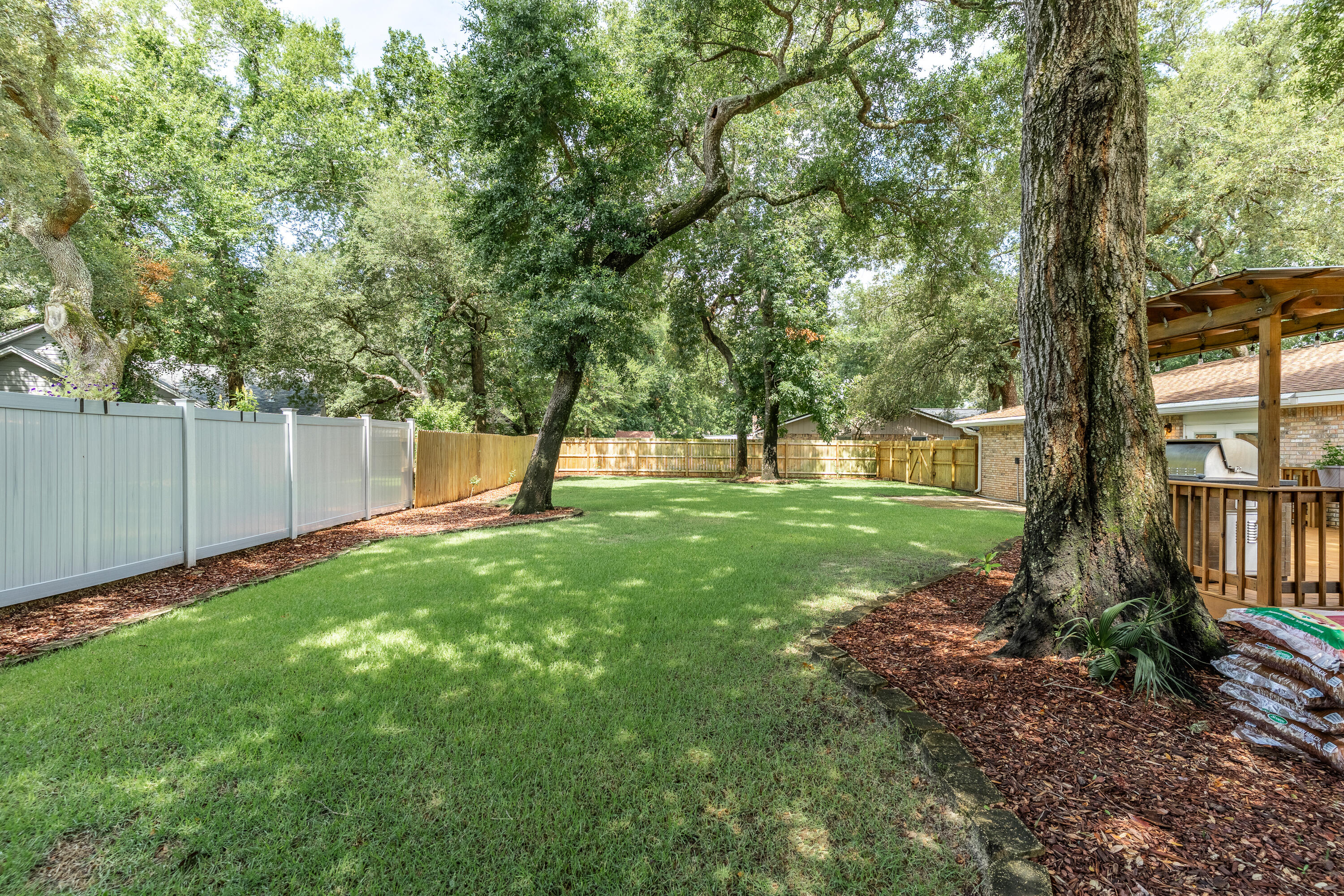 149 Raintree Boulevard Niceville, FL 32578 - Photo 50 of 72 a view of a yard with a tree