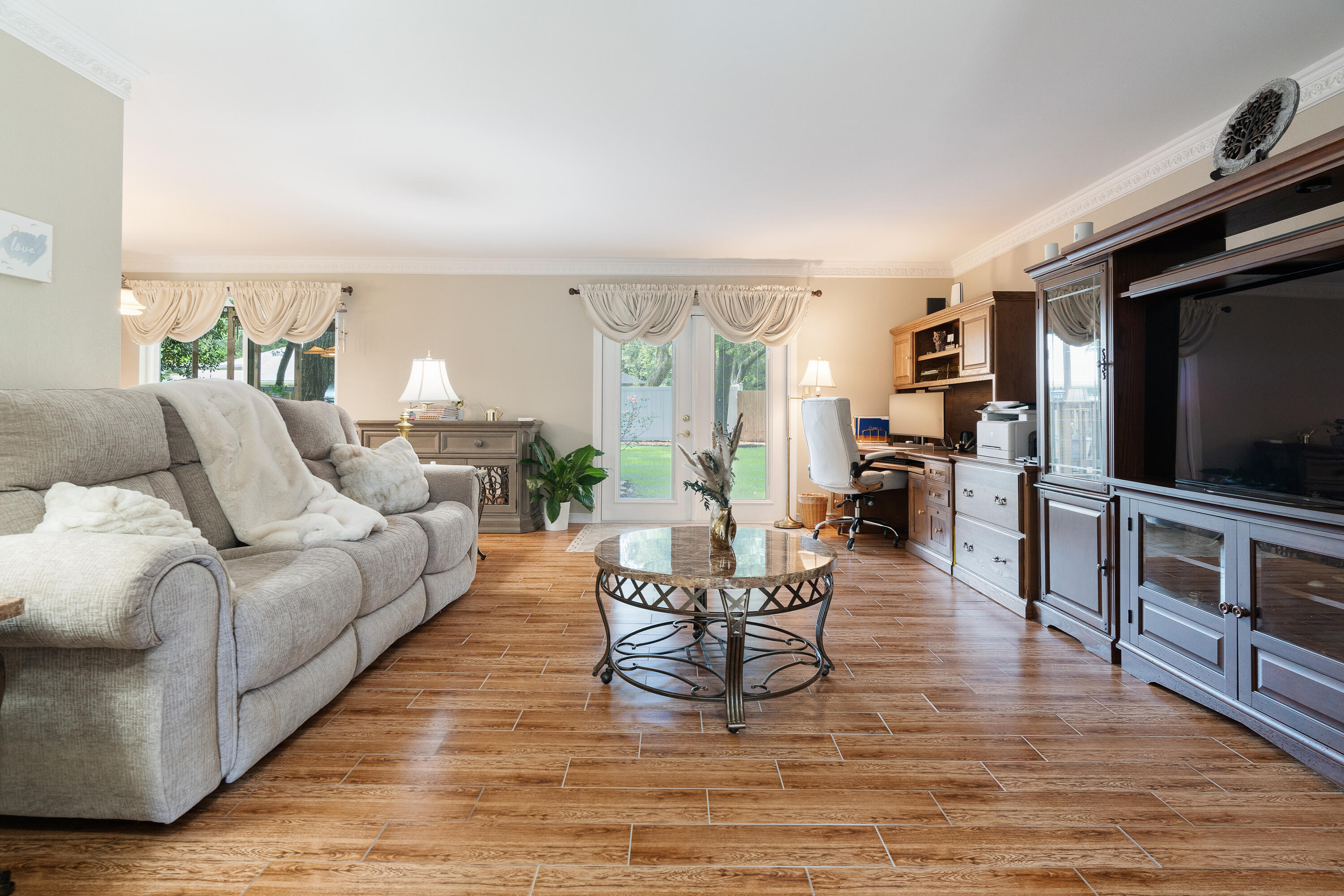 149 Raintree Boulevard Niceville, FL 32578 - Photo 6 of 72 a living room with furniture and a flat screen tv