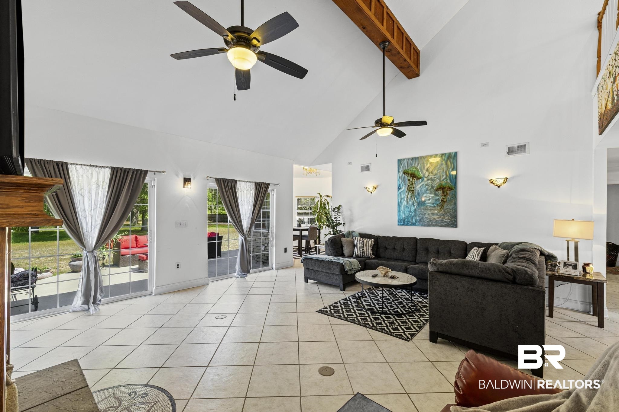 32875 Faircloth Road Lillian, AL 36549 - Photo 28 of 85 Living area featuring a ceiling fan, lofted ceiling, and light tile patterned floors