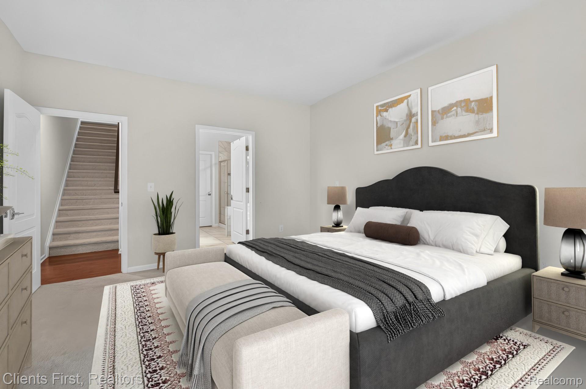 4699 Bingham Road Canton, MI 48188 - Photo 17 of 47 Carpeted bedroom featuring light gray walls, a dark upholstered headboard, and two doorways, one opening to a carpeted staircase with wood-finish landing and the other to a bathroom with a tiled shower
