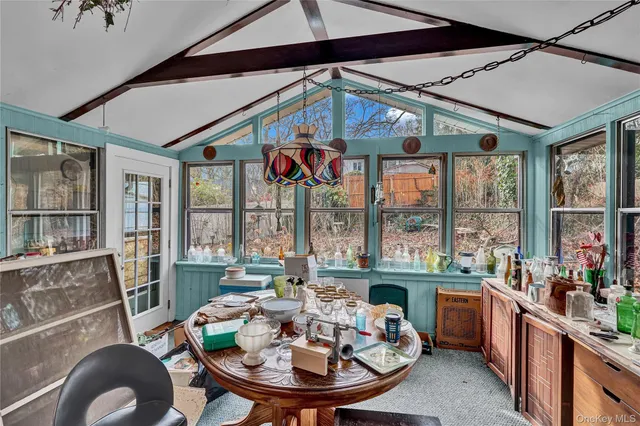 a dining room with furniture a livingroom view and wooden floor