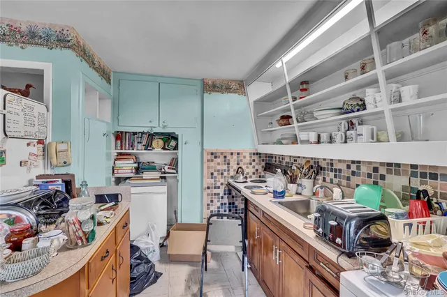 a kitchen with stainless steel appliances a stove a sink and a refrigerator