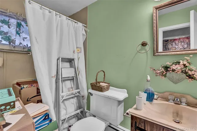 a bathroom with a toilet sink and mirror