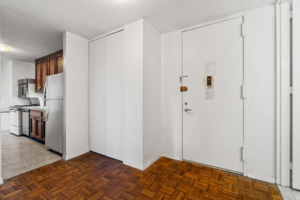 531 Main Street, Unit 504 Manhattan, NY 10044 - Photo 12 of 14 a view of a room with a wardrobe space