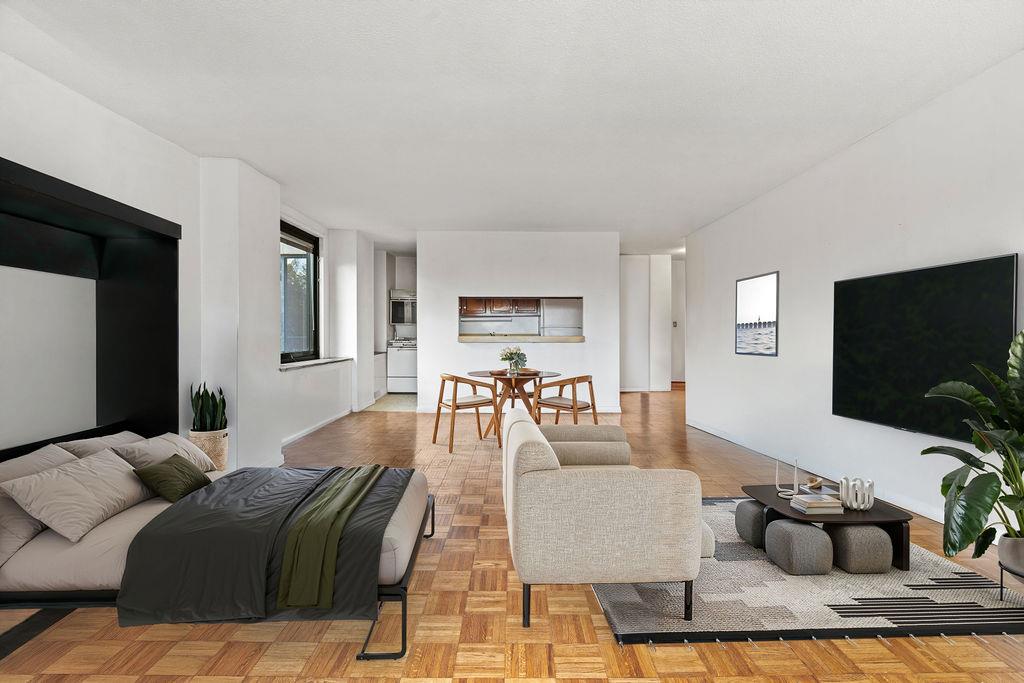 531 Main Street, Unit 504 Manhattan, NY 10044 - Photo 2 of 14 a living room with furniture and a flat screen tv