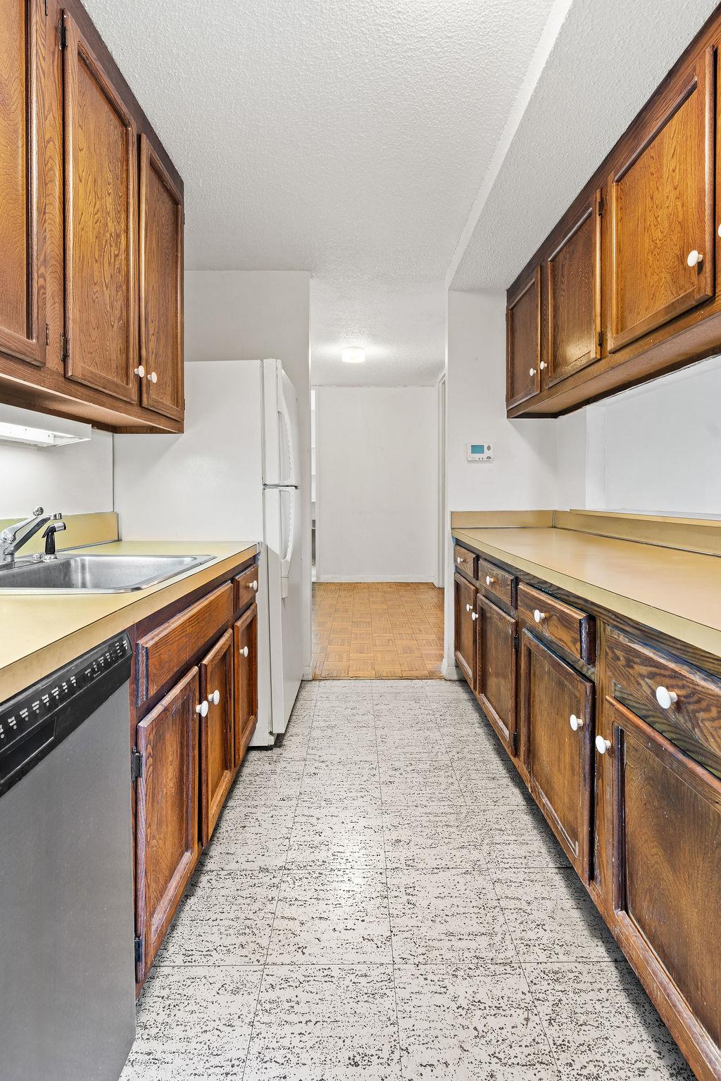 531 Main Street, Unit 504 Manhattan, NY 10044 - Photo 8 of 14 a large kitchen with stainless steel appliances granite countertop a sink and cabinets