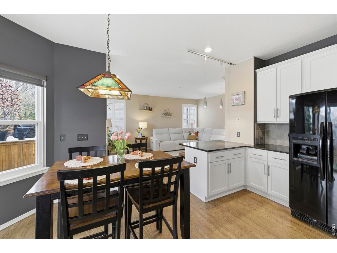 9734 Red Oakes Drive Highlands Ranch, CO 80126 - Photo 13 of 40 a kitchen with stainless steel appliances a table chairs refrigerator and cabinets