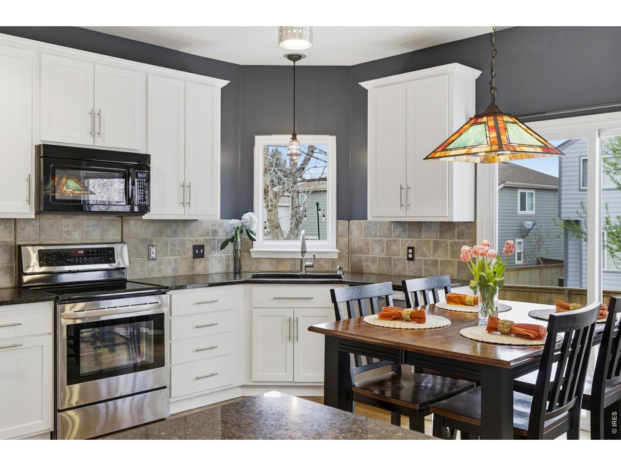 9734 Red Oakes Drive Highlands Ranch, CO 80126 - Photo 14 of 40 a kitchen with a stove a sink and a microwave