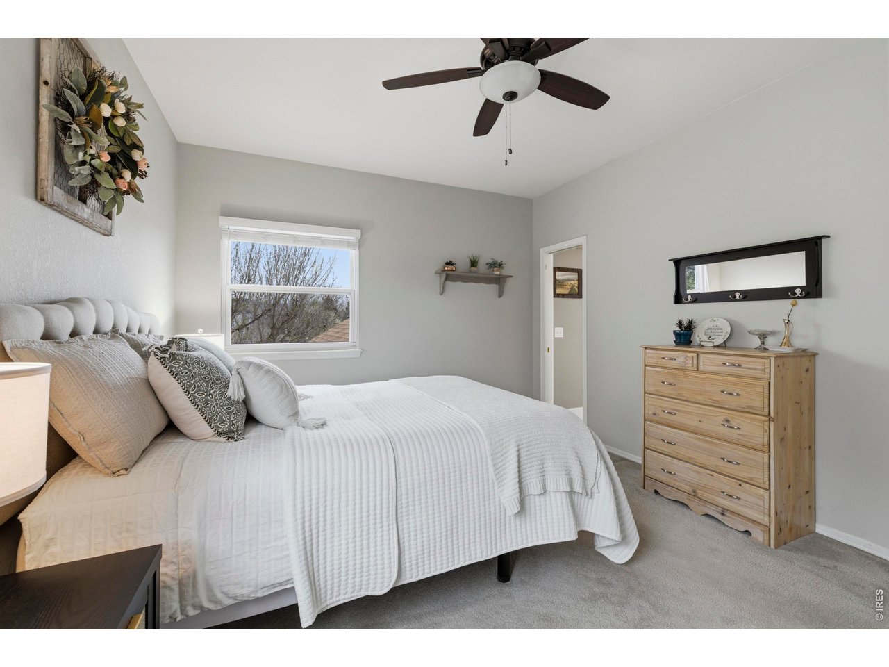 9734 Red Oakes Drive Highlands Ranch, CO 80126 - Photo 20 of 40 a bedroom with a bed and a chandelier