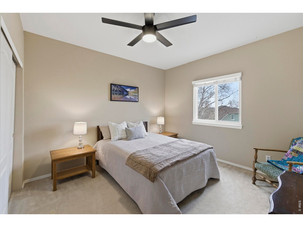 9734 Red Oakes Drive Highlands Ranch, CO 80126 - Photo 21 of 40 a bedroom with a bed and a painting on the wall