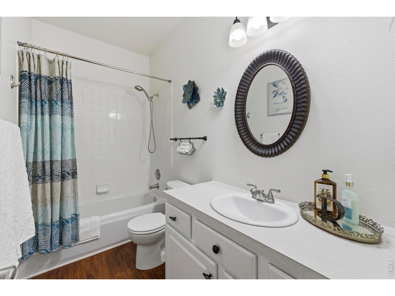 9734 Red Oakes Drive Highlands Ranch, CO 80126 - Photo 25 of 40 a bathroom with a toilet a sink a mirror and shower