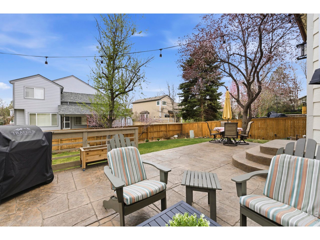 9734 Red Oakes Drive Highlands Ranch, CO 80126 - Photo 35 of 40 a view of a patio with couches table and chairs with wooden floor