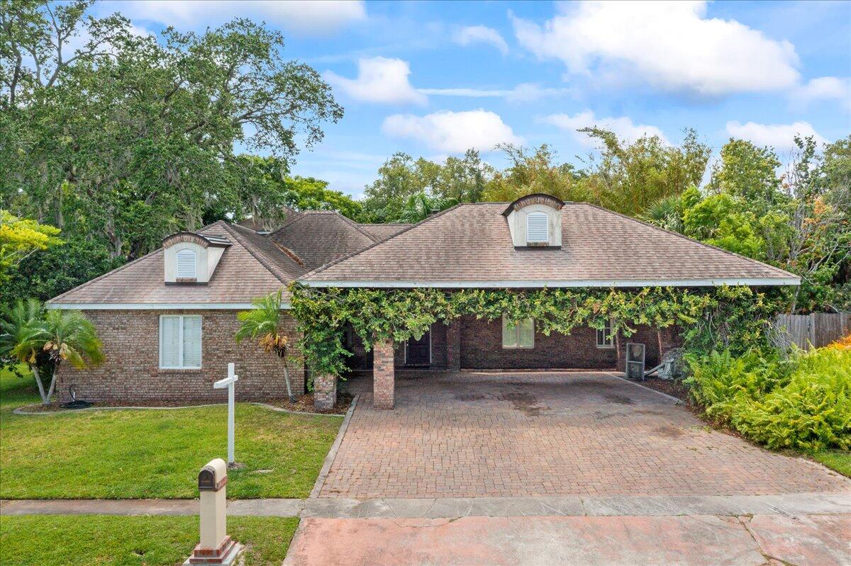 1244 Cimarron Circle Northeast Palm Bay, FL 32905 - Photo 1 of 38 a backyard of a house with lots of green space
