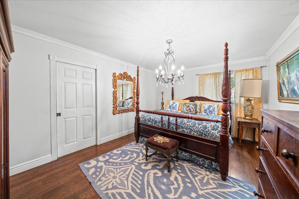 1244 Cimarron Circle Northeast Palm Bay, FL 32905 - Photo 15 of 38 a bedroom with furniture and a chandelier