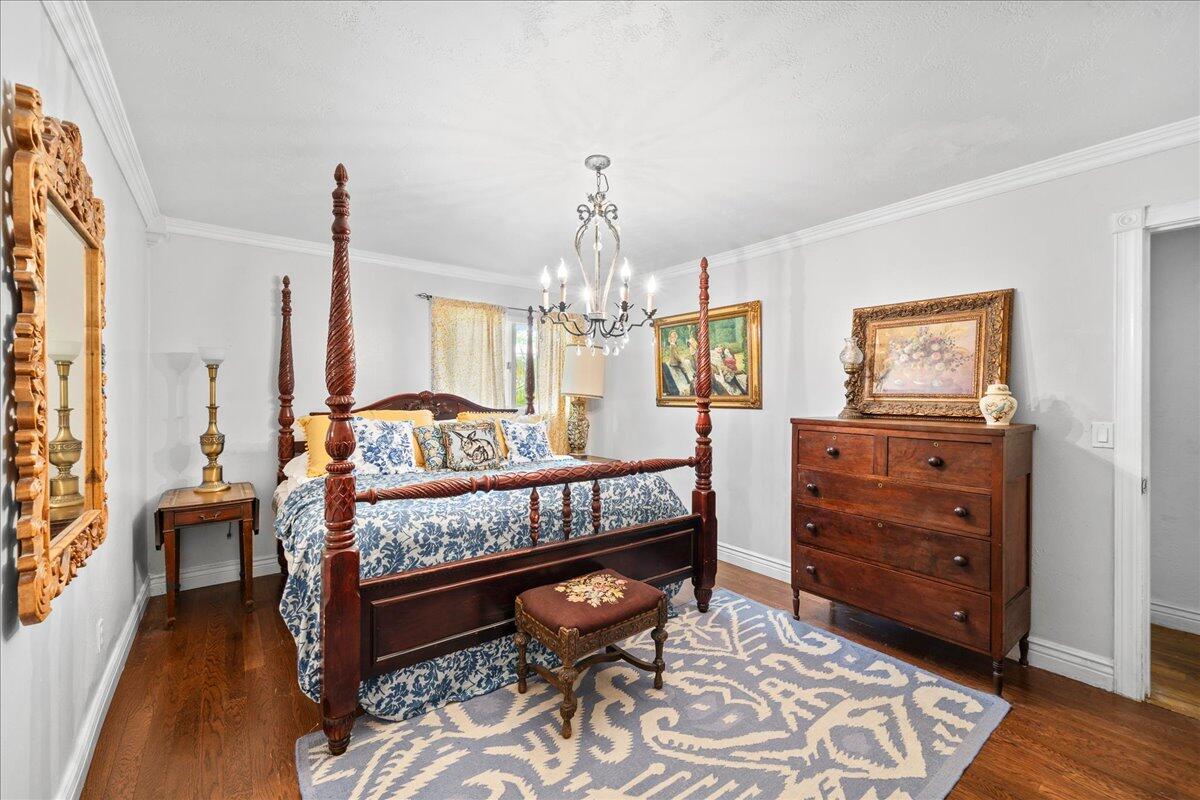 1244 Cimarron Circle Northeast Palm Bay, FL 32905 - Photo 16 of 38 a bedroom with furniture and a chandelier