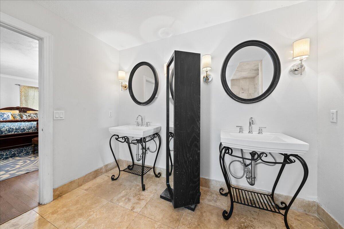1244 Cimarron Circle Northeast Palm Bay, FL 32905 - Photo 18 of 38 a bathroom with a sink a mirror and a window