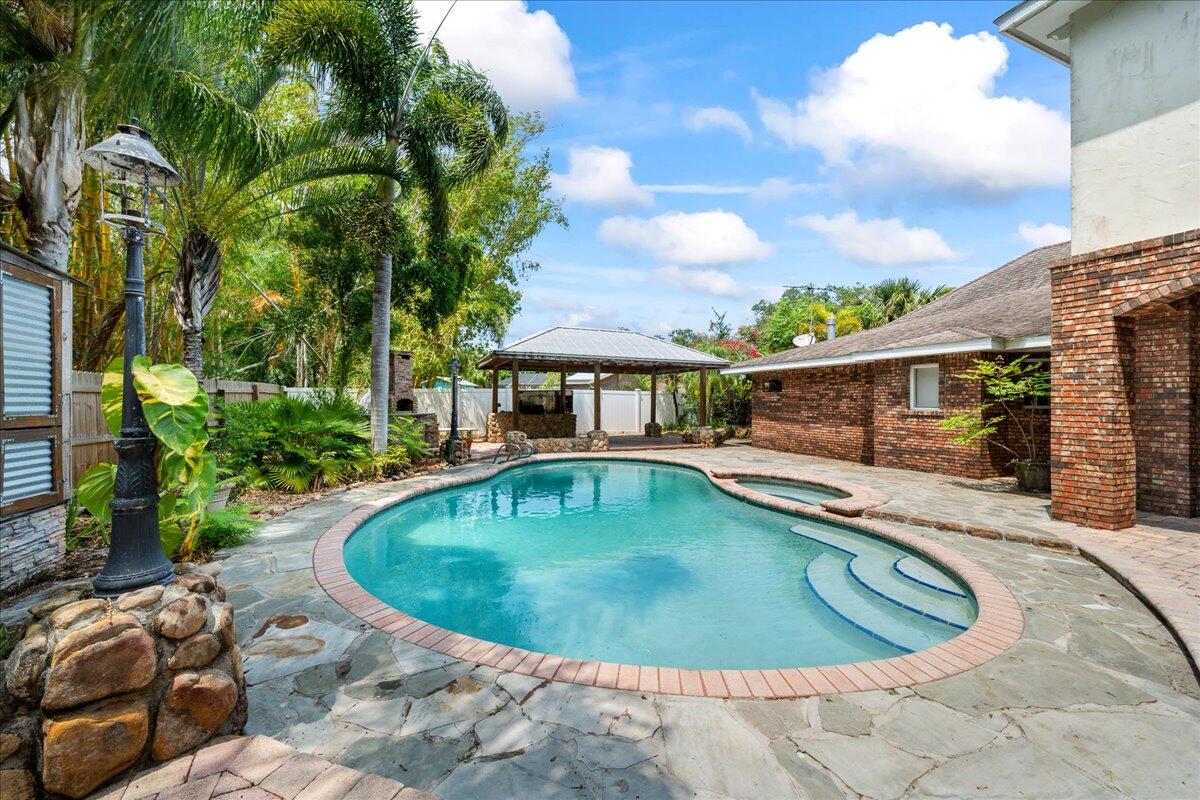 1244 Cimarron Circle Northeast Palm Bay, FL 32905 - Photo 29 of 38 a view of a swimming pool with a patio