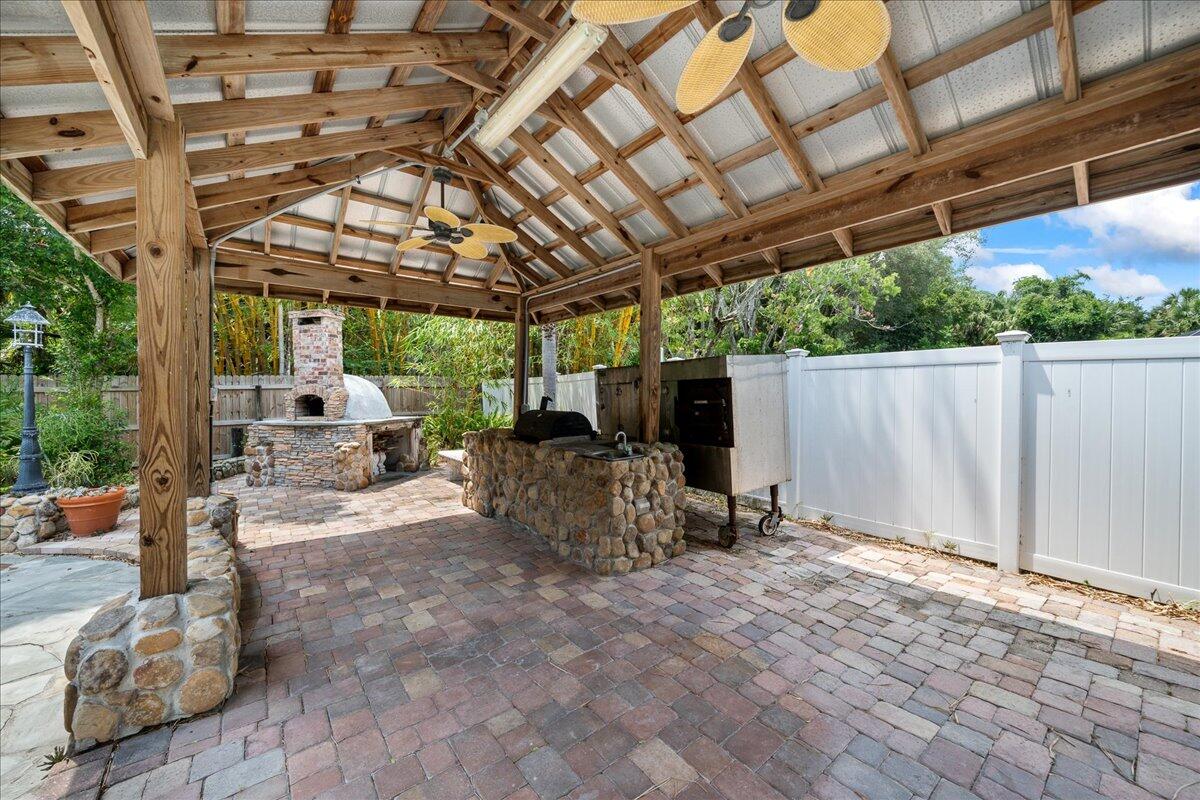 1244 Cimarron Circle Northeast Palm Bay, FL 32905 - Photo 31 of 38 a view of backyard with table and chairs and potted plants