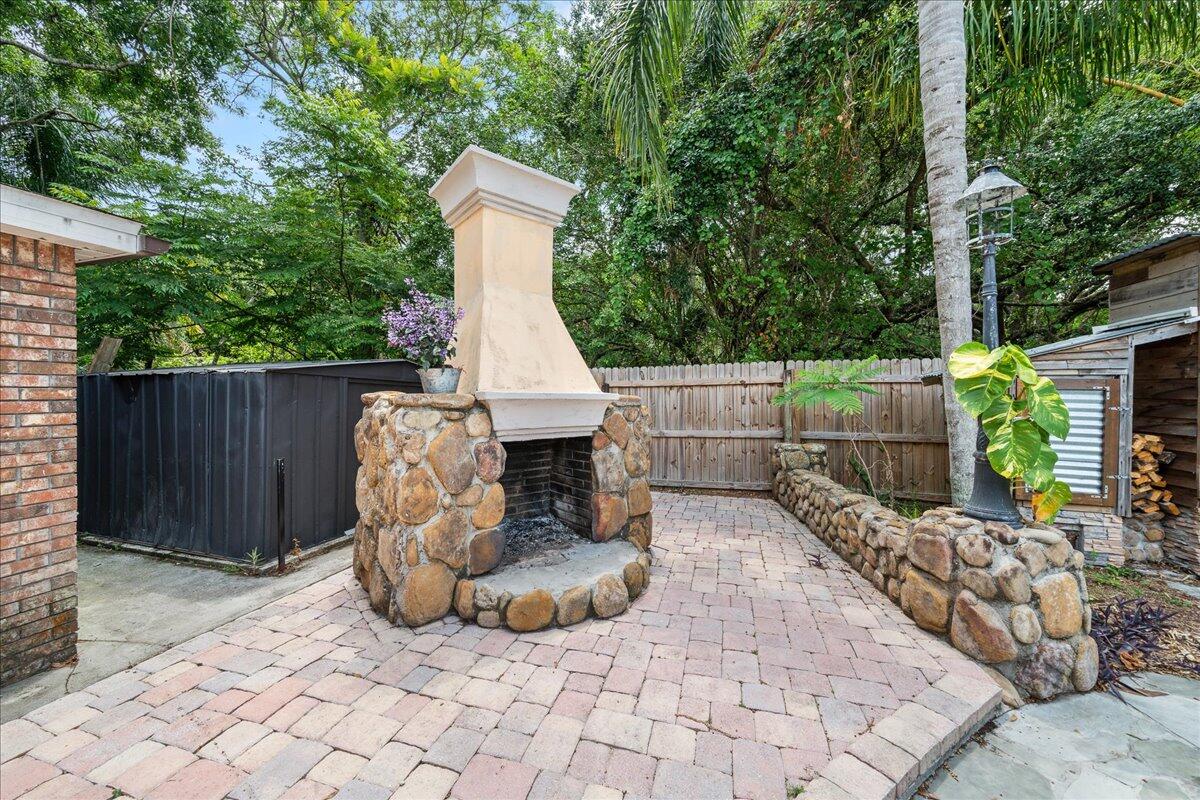 1244 Cimarron Circle Northeast Palm Bay, FL 32905 - Photo 35 of 38 a view of backyard with outdoor seating and trees