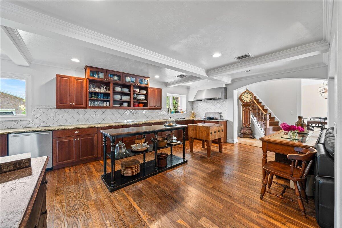 1244 Cimarron Circle Northeast Palm Bay, FL 32905 - Photo 4 of 38 a kitchen with stainless steel appliances granite countertop a stove top oven a dining table and chairs with wooden floor