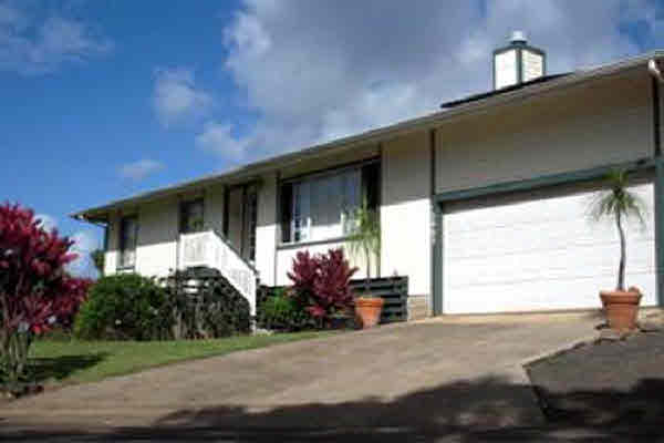 4755 Kikala Road, Unit 2 Kalaheo, HI 96741 - Photo 4 of 24 a front view of a house with a yard