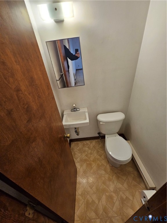 7866 Wilton Road, Unit 1 Henrico, VA 23231 - Photo 20 of 22 a white toilet sitting next to a small bathroom