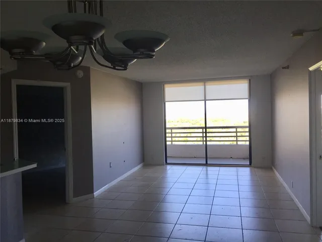 a view of a room with an empty space and a window