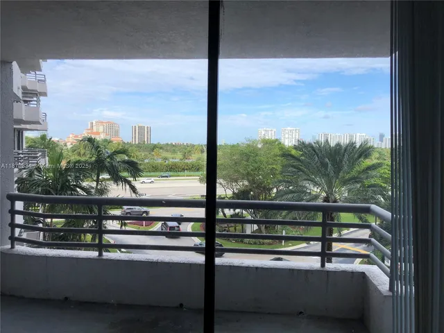 a balcony with furniture and a potted plant