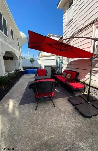 a backyard of a house with barbeque oven table and chairs