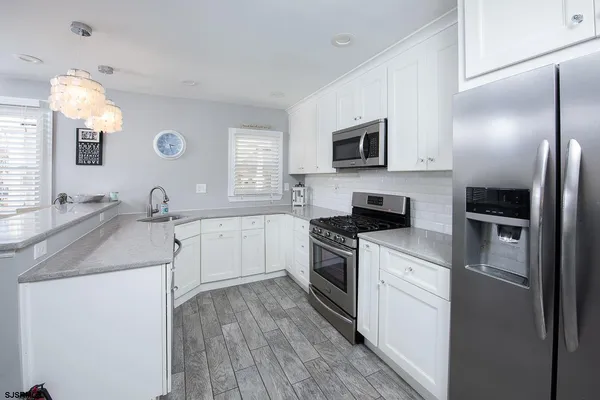 a kitchen with a sink stove and refrigerator