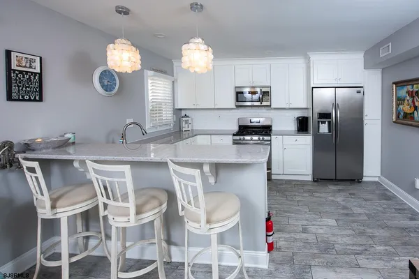 a kitchen with a dining table and chairs