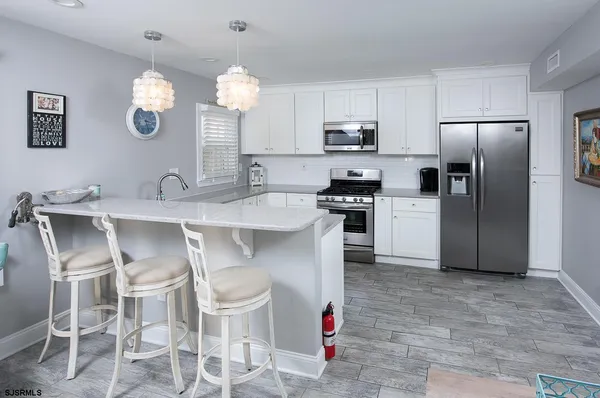 a kitchen with cabinets and stainless steel appliances