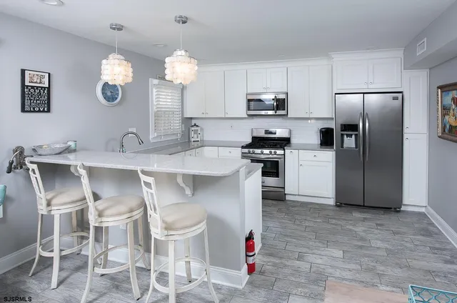 a kitchen with cabinets and stainless steel appliances