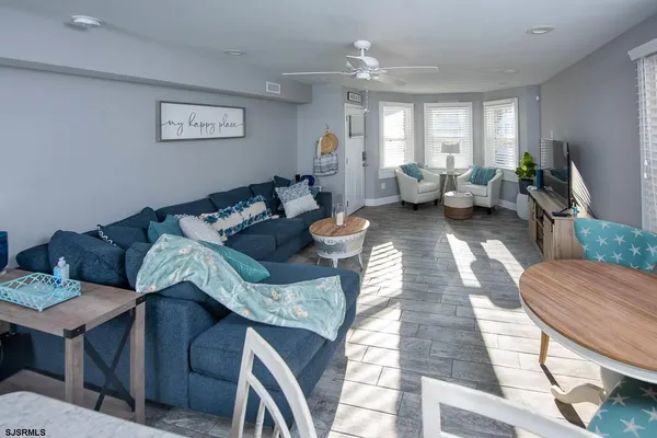 a living room with furniture and wooden floor