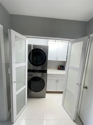 a utility room with sink dryer and washer