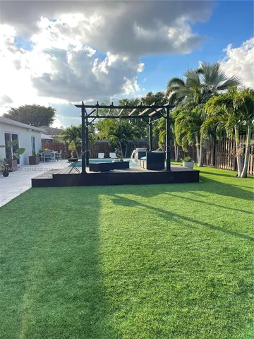 a view of a yard with a house in the background