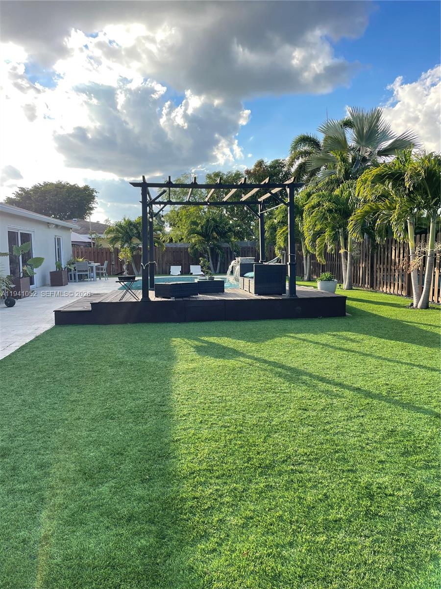 6901 Northwest 82nd Court Tamarac, FL 33321 - Photo 12 of 13 a view of a yard with a house in the background