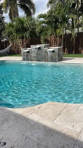 a view of a swimming pool with a yard