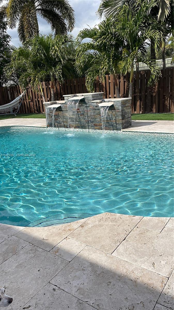 6901 Northwest 82nd Court Tamarac, FL 33321 - Photo 13 of 13 a view of a swimming pool with a yard